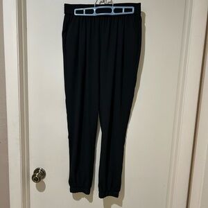 Black ankle length haram pants with side pockets, elastic waist.
